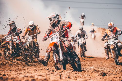 Free Dynamic motocross race capturing riders in action on a muddy track in Gdańsk, Poland. Stock Photo