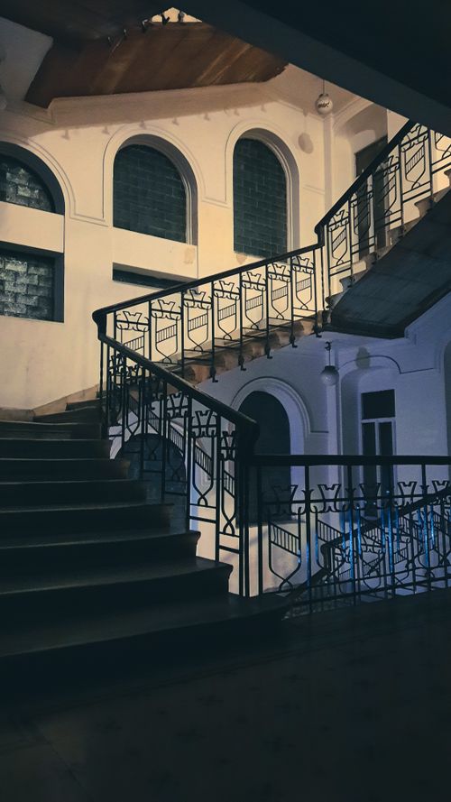 Free An artistic view of a staircase inside a traditional Istanbul building with arched windows. Stock Photo