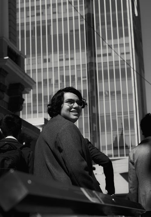 Grayscale Photo of a Man in Black Suit Jacket Wearing Eyeglasses