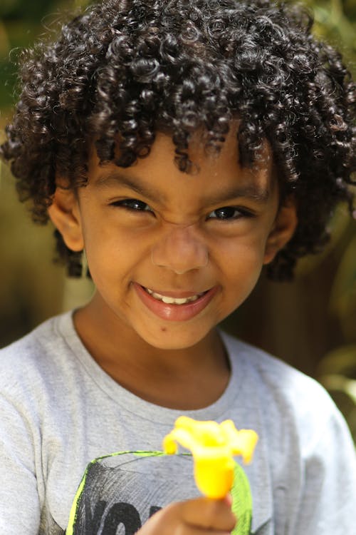 A Smiling Boy with Curly Hair