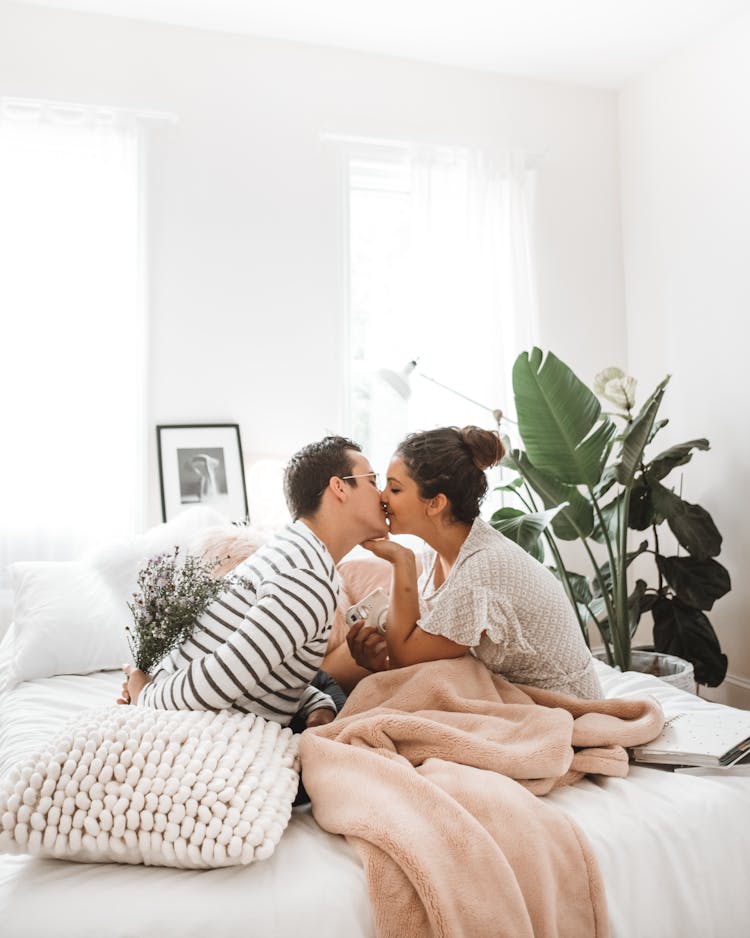 Couple Kissing On Bed