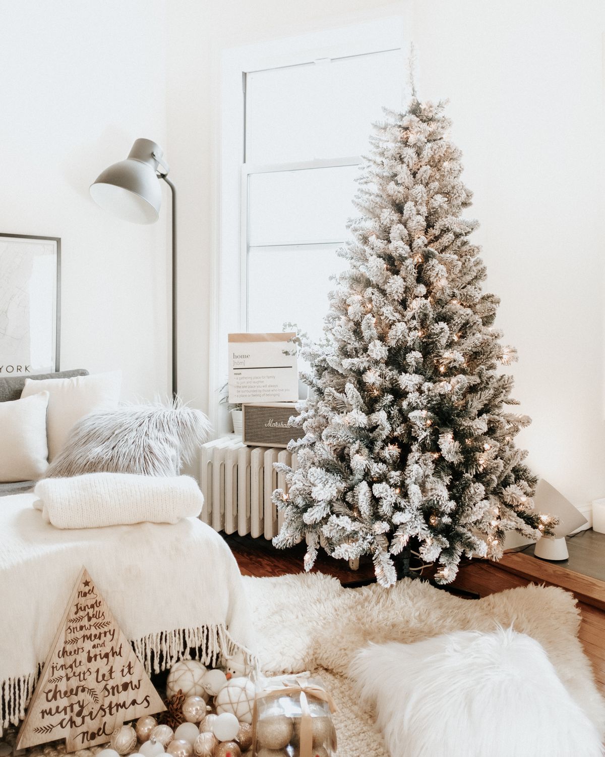Snow-flocked Christmas tree in a cozy home interior