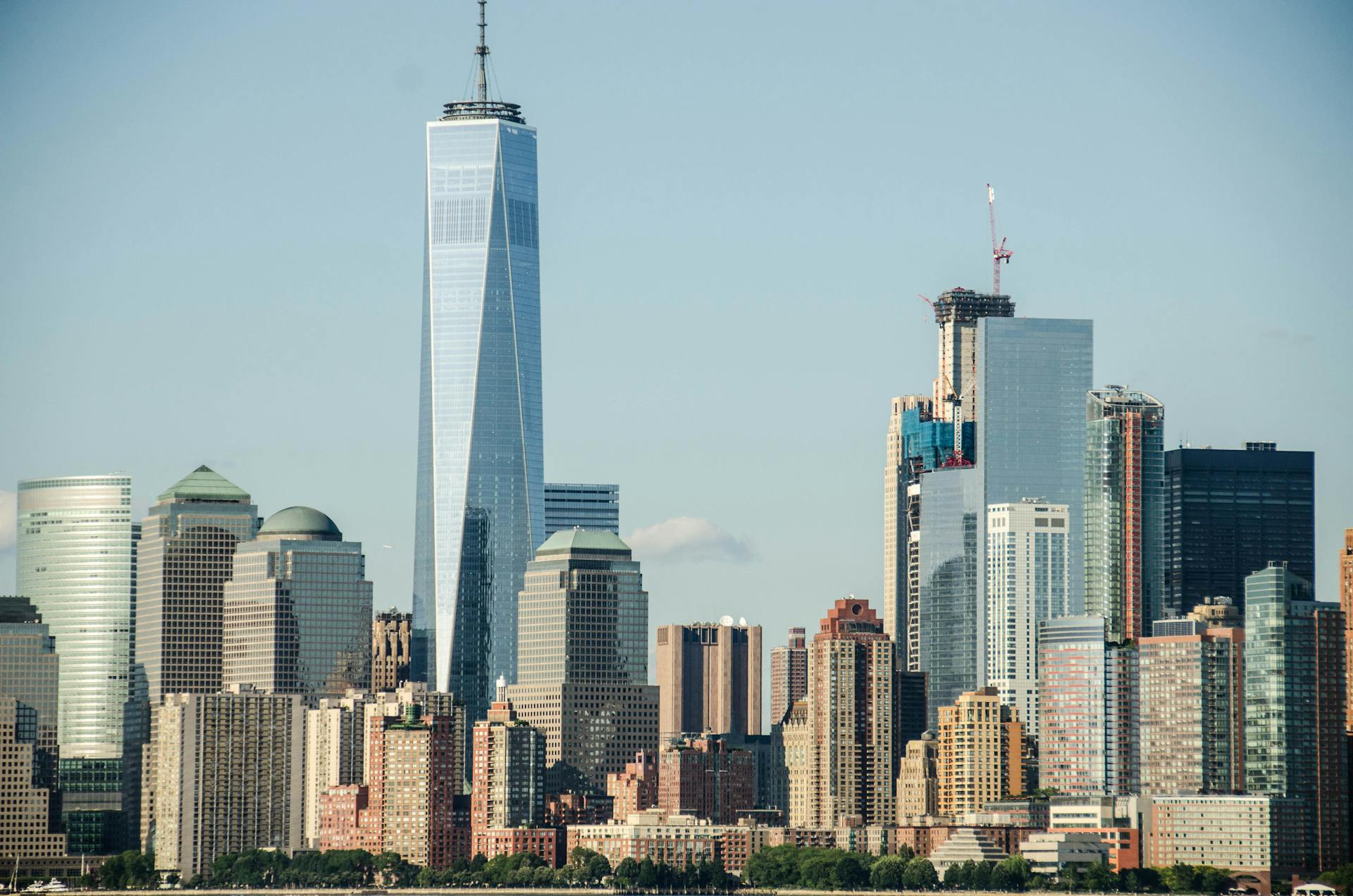 A stunning view of New York City's skyline with One World Trade Center prominently displayed.