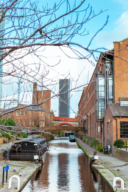 Free Scenic view of Rochdale Canal with Beetham Tower and historic buildings, Manchester, England. Stock Photo