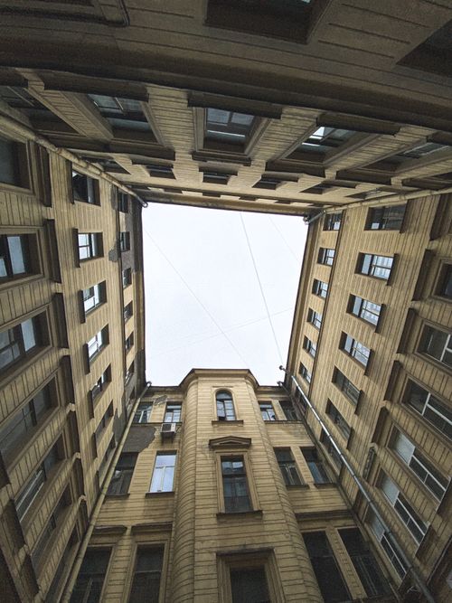 Free Captivating upward perspective of a historic building's symmetrical facade with a clear sky above. Stock Photo