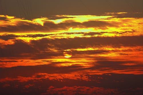 Free A Sun Setting over the Yellow and Red Clouds Stock Photo