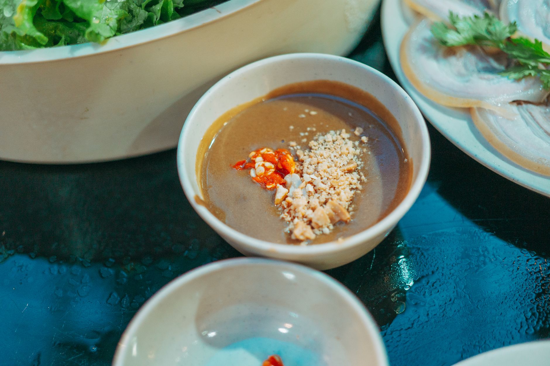 Creamy Virginia Peanut Soup served in a bowl garnished with peanuts and scallions