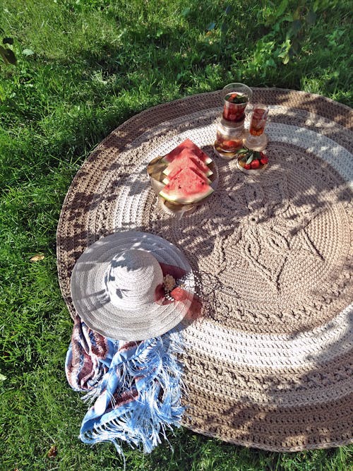 Free Food and Drinks on a Round Picnic Mat Stock Photo