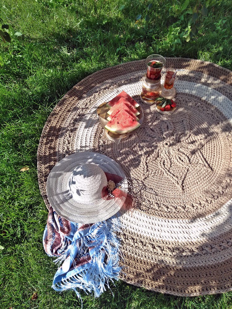 Food And Drinks On A Round Picnic Mat