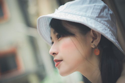 Selective Focus Photo of Woman Wearing White Cap