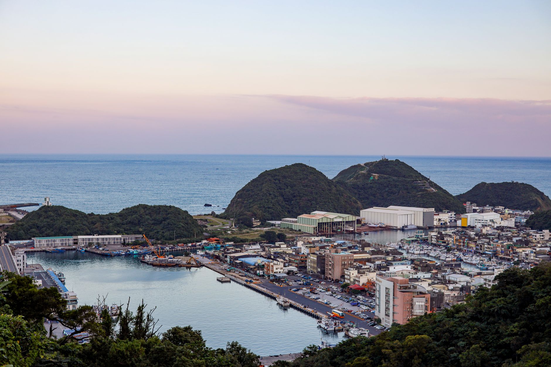 宜蘭免費與銅板價景點清單:分區攻略與省錢祕訣全整理 A beautiful aerial shot of Nanfangao Fishing Port at dusk in Yilan County, Taiwan, showcasing the harbor and surrounding landscape.