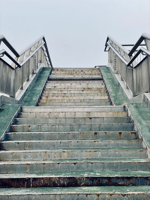 Free A dramatic low angle view of a rusty urban staircase leading upwards. Stock Photo