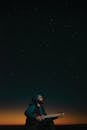 A Man Playing a Tar Under the Starry Sky