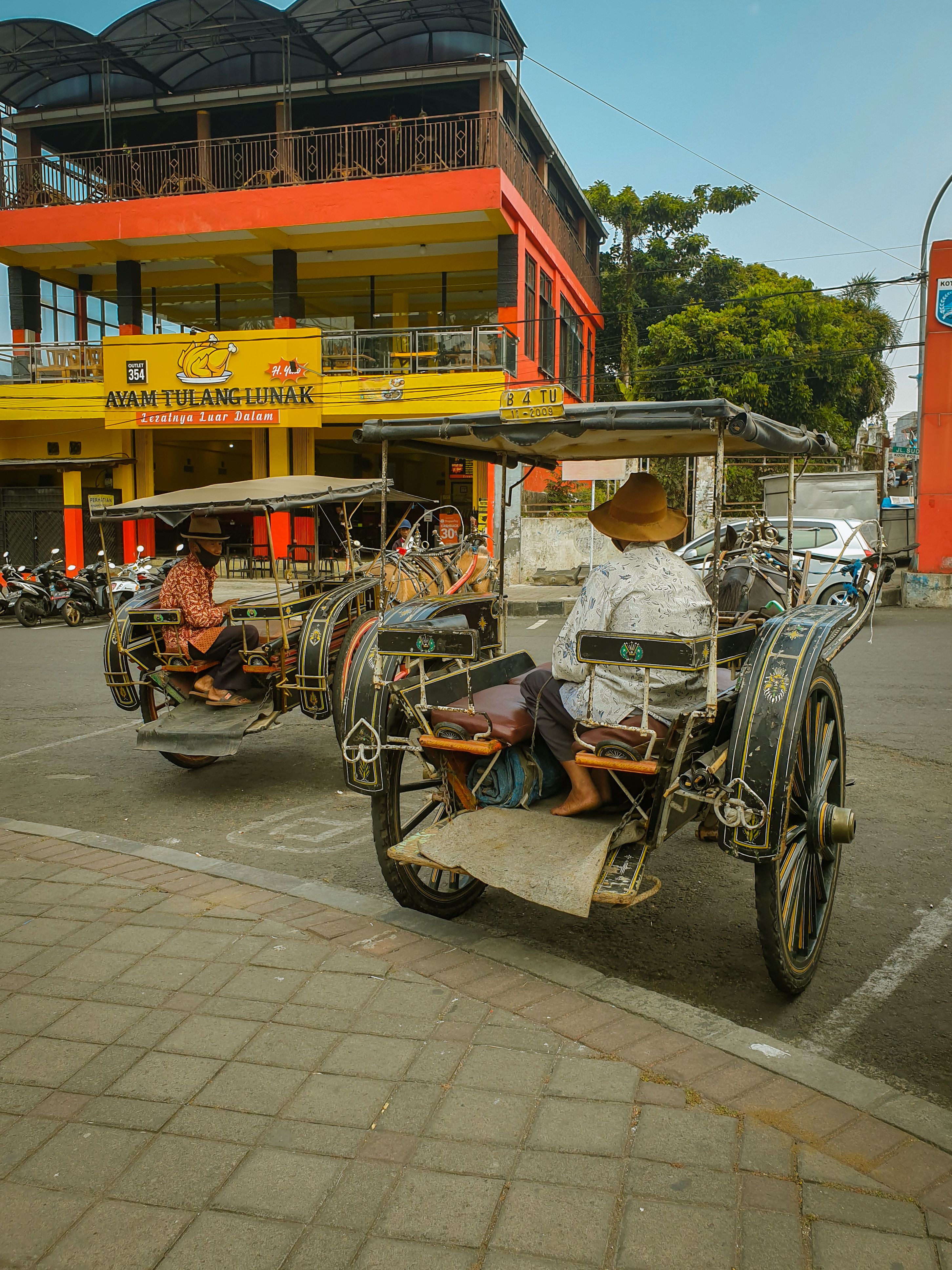 People in Traditional Carts on City Street · Free Stock Photo