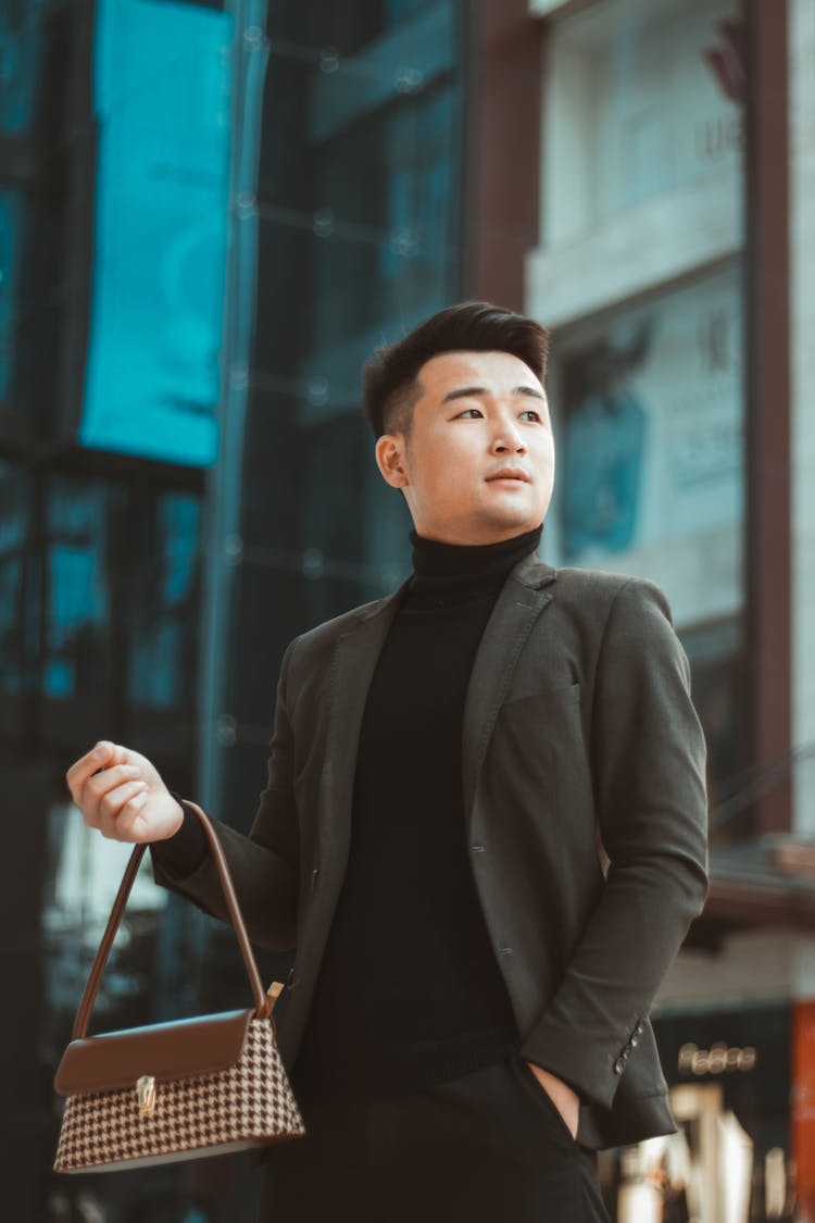 Man Holding Brown Handbag