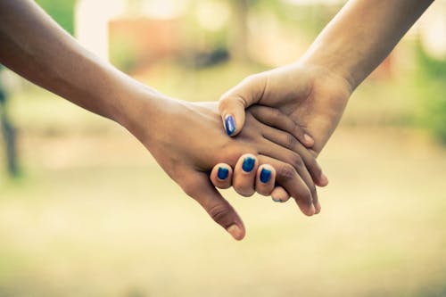 Two People Holding Hands