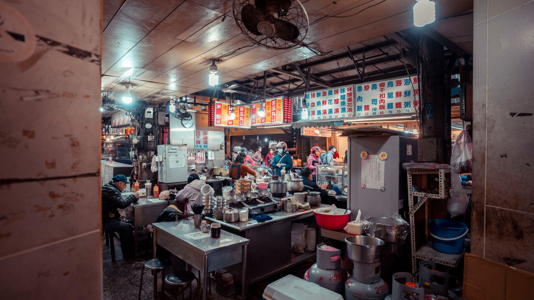 Interior of a traditional Chinese eatery bustling with diners and vibrant decor.