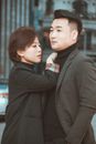 Portrait of Couple in Matching Blazers and Turtlenecks