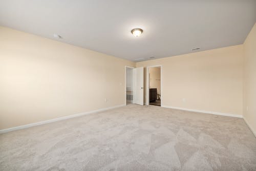 Spacious Empty Room With Carpet Flooring
