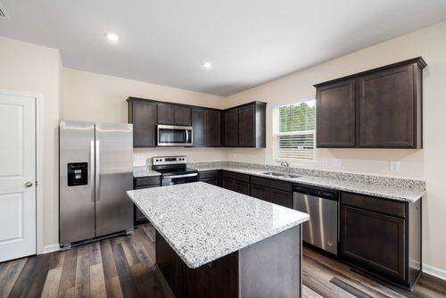 Free Luxurious modern kitchen featuring granite countertops and stainless steel appliances. Stock Photo