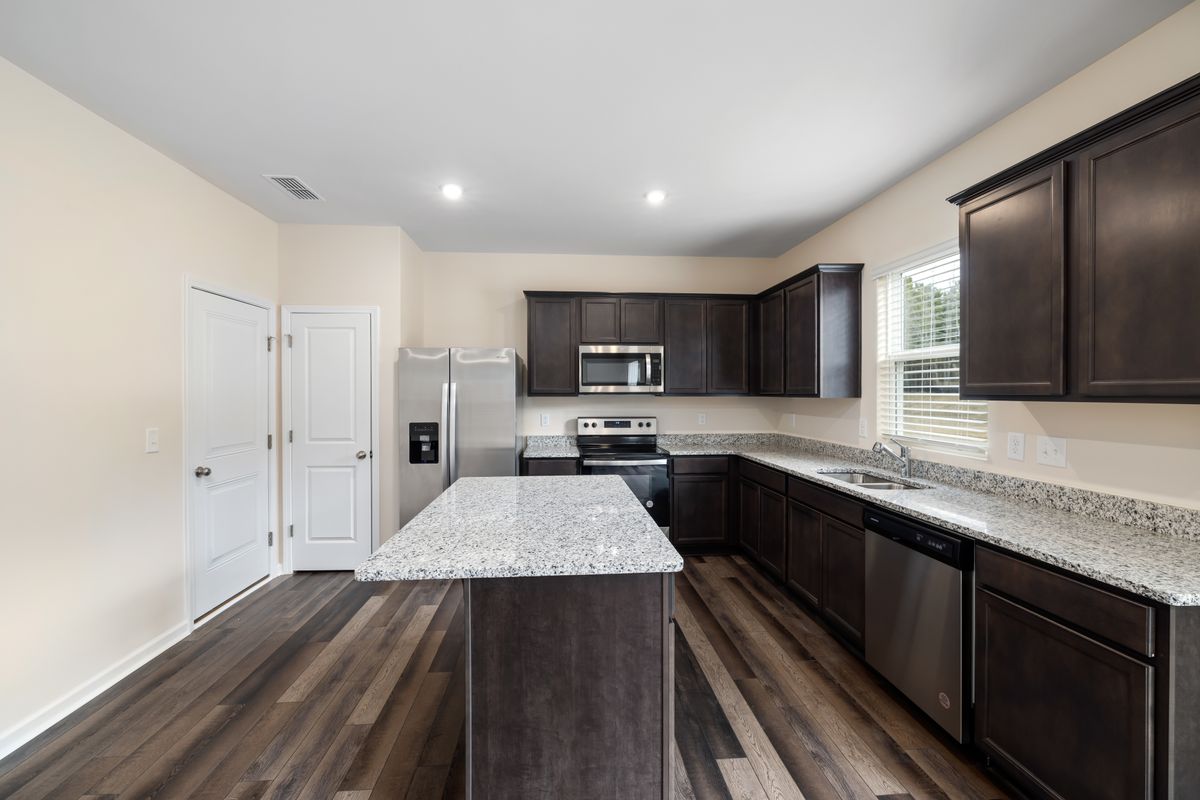 Kitchen renovation reference: dark timber cabinetry and a stone island bench (stock placeholder)