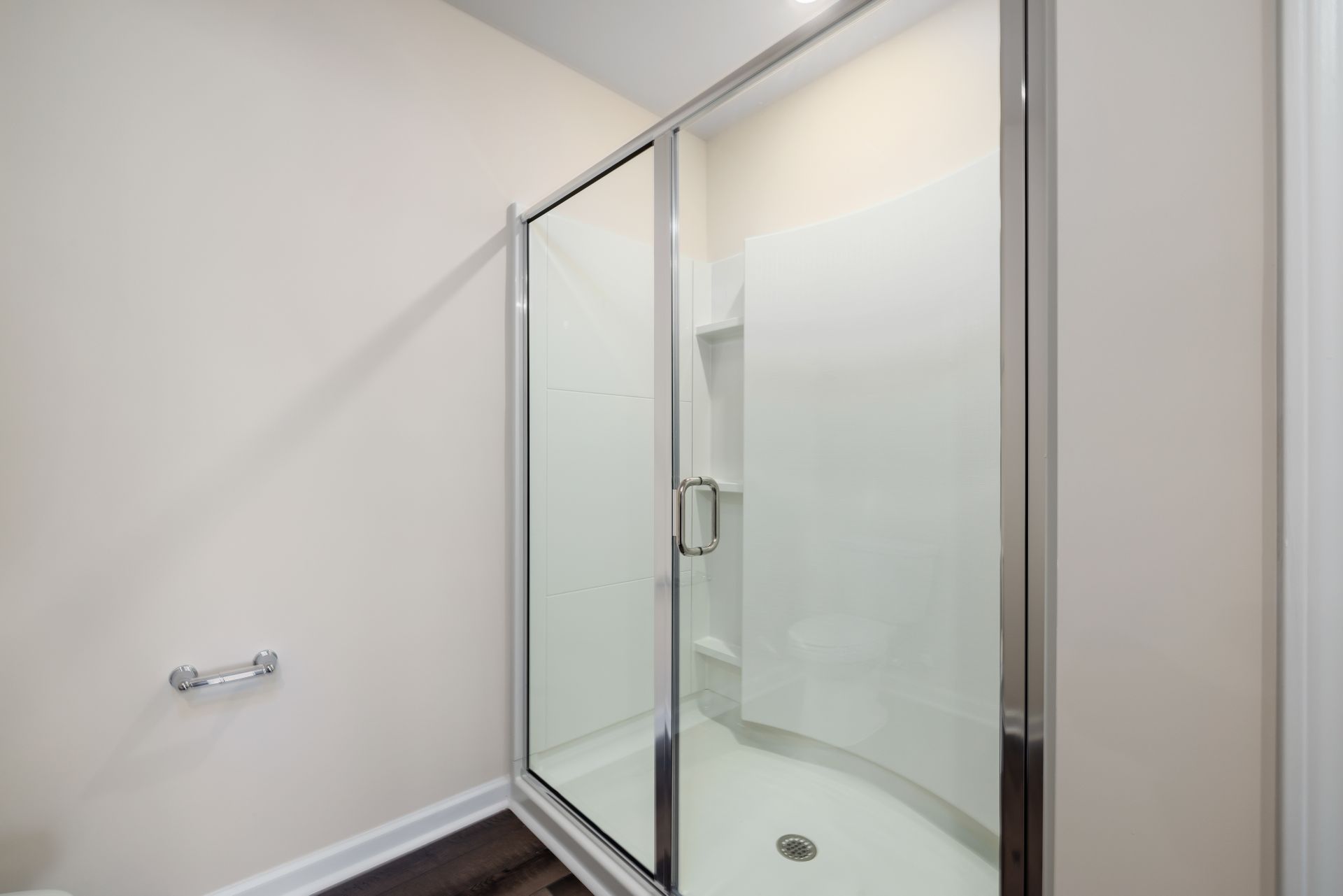 Contemporary glass shower with minimalist design, showing clean and spacious interior.