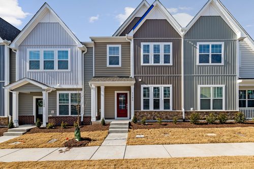 Free Charming modern townhouses in a suburban residential area with neat landscaping. Stock Photo