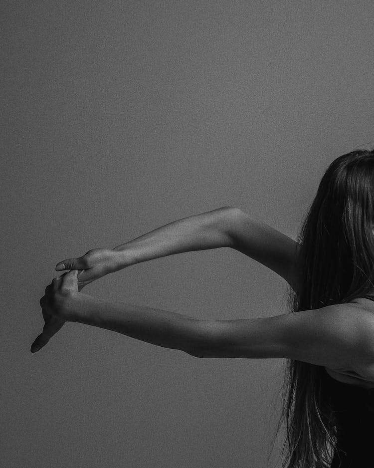 Grayscale Photo Of A Person Doing Arms Stretching Exercise