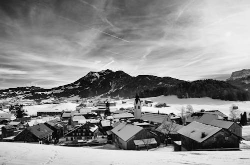 Grayscale Photo of Winter Landscape of Houses