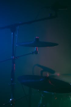 A dramatic shot of a drum set under stage lighting, perfect for a music theme.