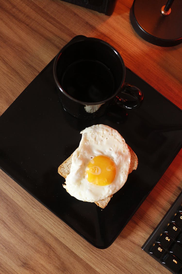 Sunny Side Up Egg On Black Ceramic Plate