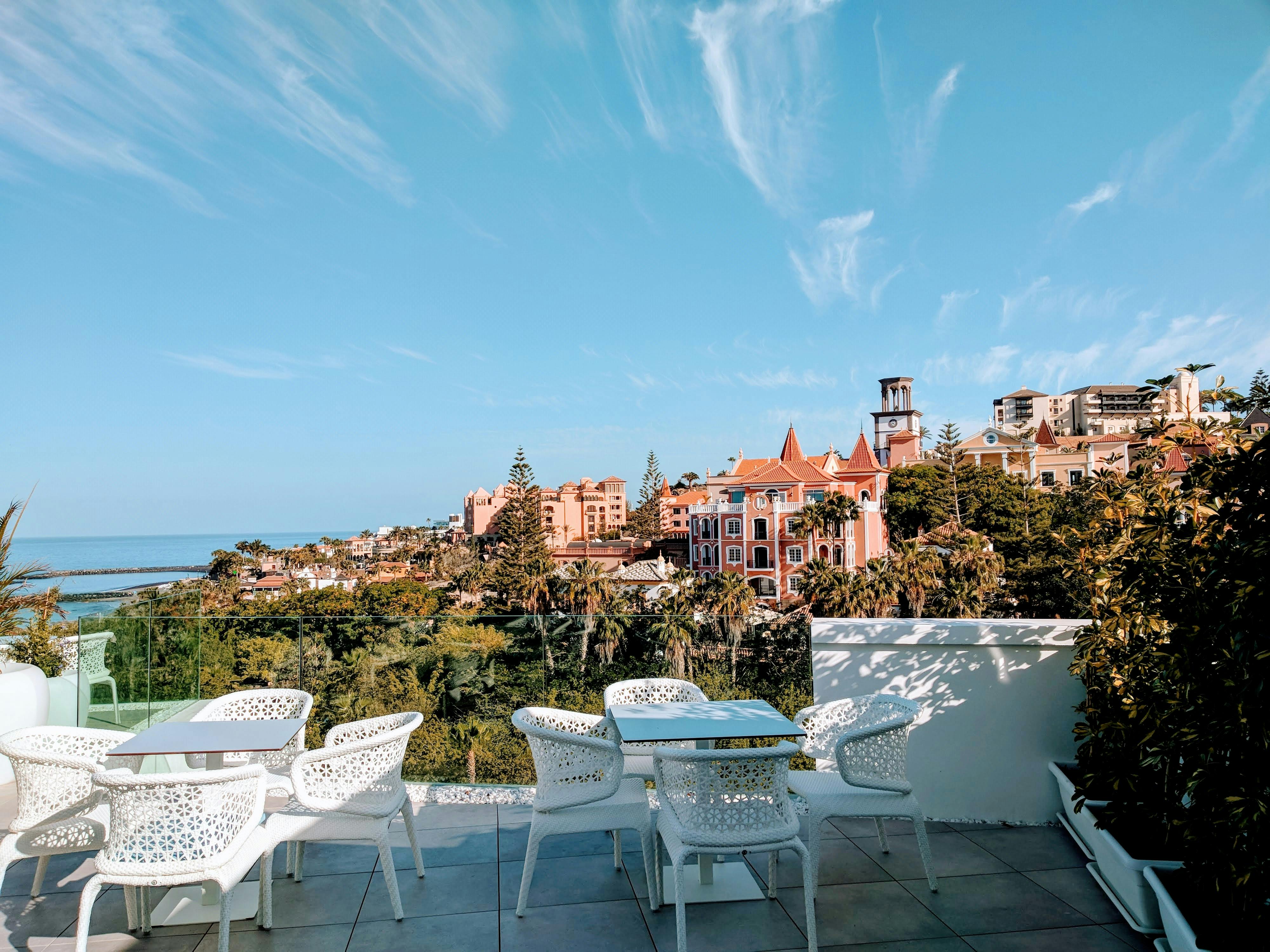 Relaxing patio with scenic view of Costa Adeje's architecture and sea in Spain.
