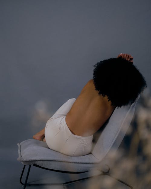 Shirtless Woman Lying on Chair