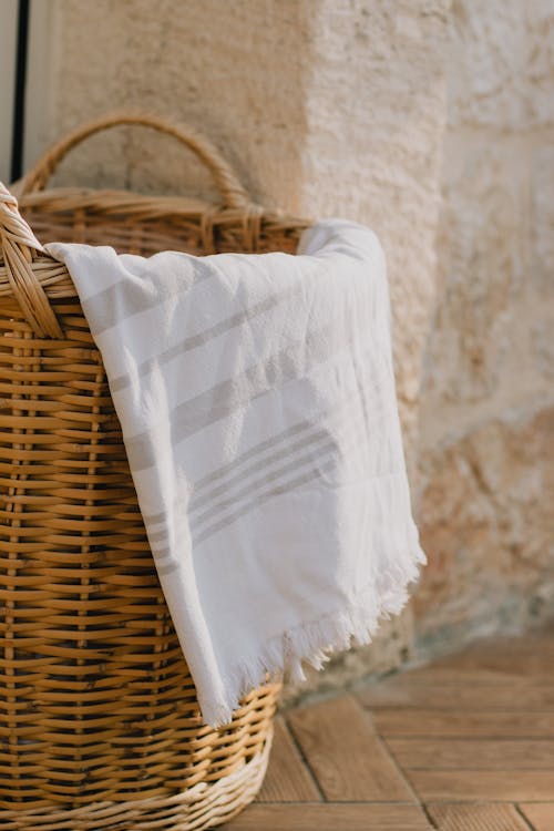 Free A White Towel on a Woven Basket Stock Photo