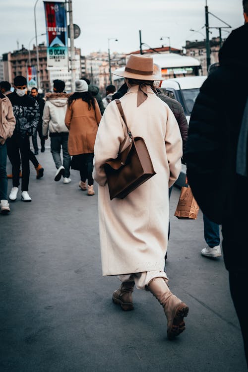 Woman in Coat among People on Street 
