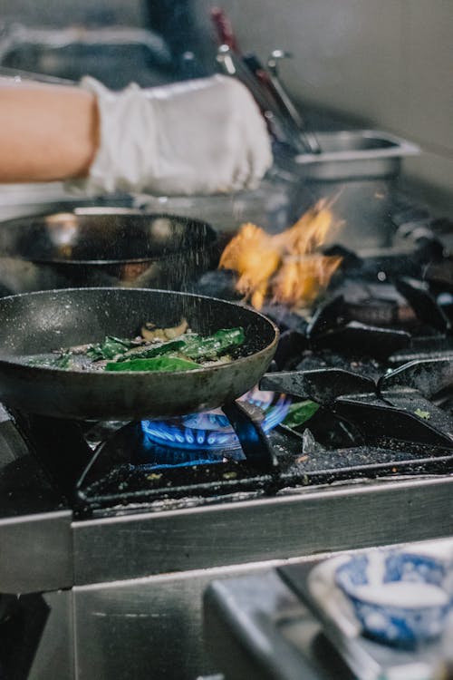 A Person Cooking using a Stove