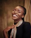 Smiling Afro-American Beauty in Black Blouse and Scarf