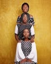 Three Afro-American Women One after Another Wearing Spotted Brown and White Dresses