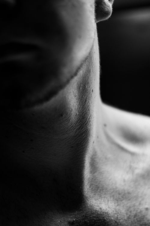 Free Artistic black and white close-up photograph of a human neck capturing texture and light. Stock Photo