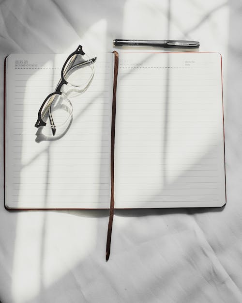 Eyeglasses on Top of a Notebook 