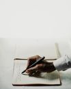 Person Writing on White Paper