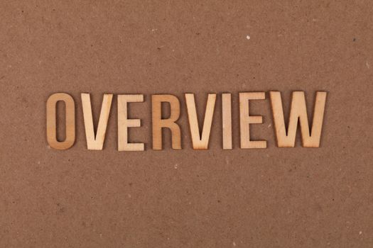 High-resolution image of wooden letters spelling 'OVERVIEW' on a brown background.