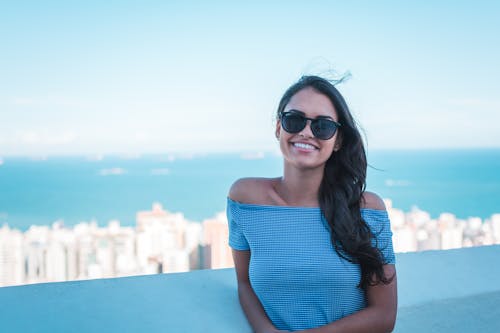 Woman Wearing Blue Off-shoulder Top Smiling