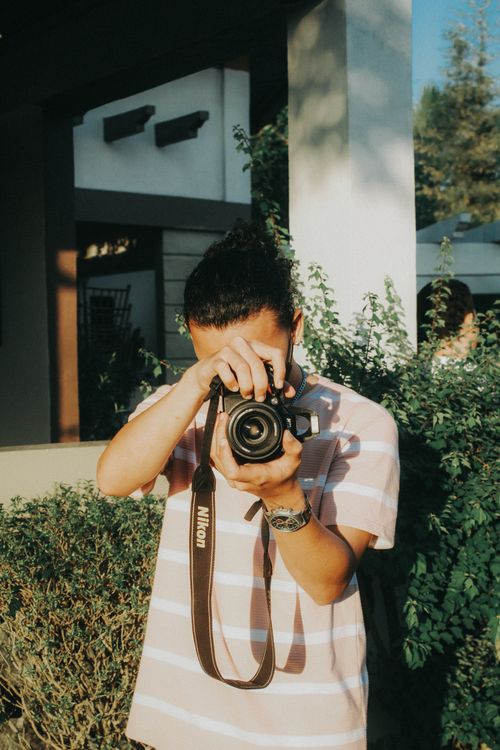 A Person Using a DSLR Camera · Free Stock Photo