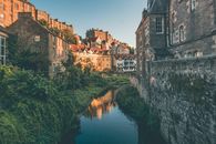 Brown Concrete Building Beside River
