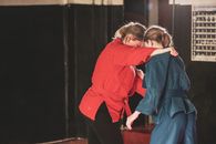 Woman in Red Hoodie Kissing Woman in Blue Denim Jacket