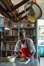 Man in White and Red Long Sleeve Shirt Standing Near Brown Wooden Shelves