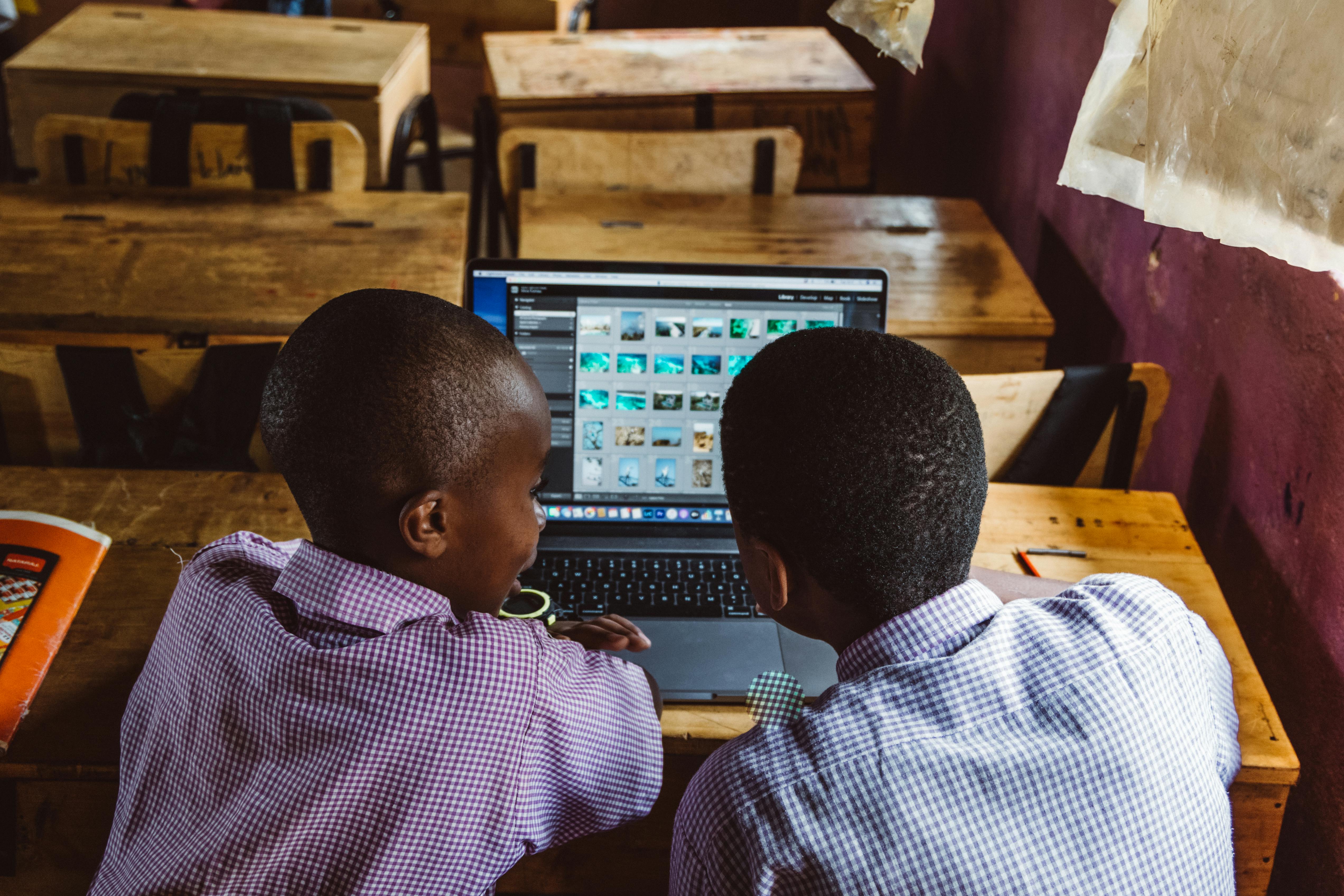 young boys using laptop in the classroom