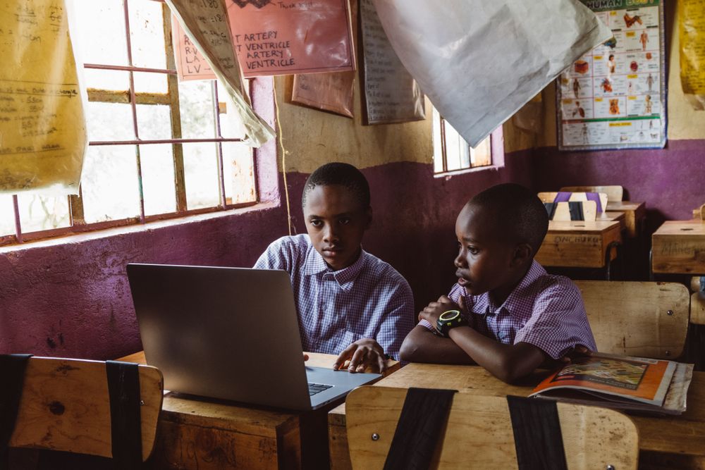 Two students sharing a laptop in class