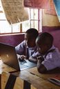 Young Boys using Laptop while Studying